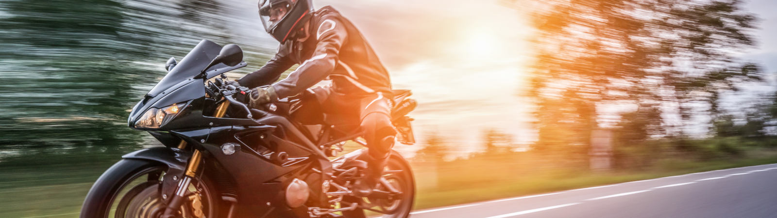 person riding motorcycle at sunset