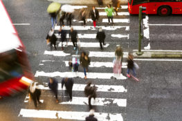 pedestrians walking through a crosswalk