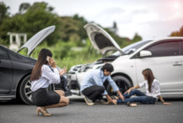 person using phone to call about car accident